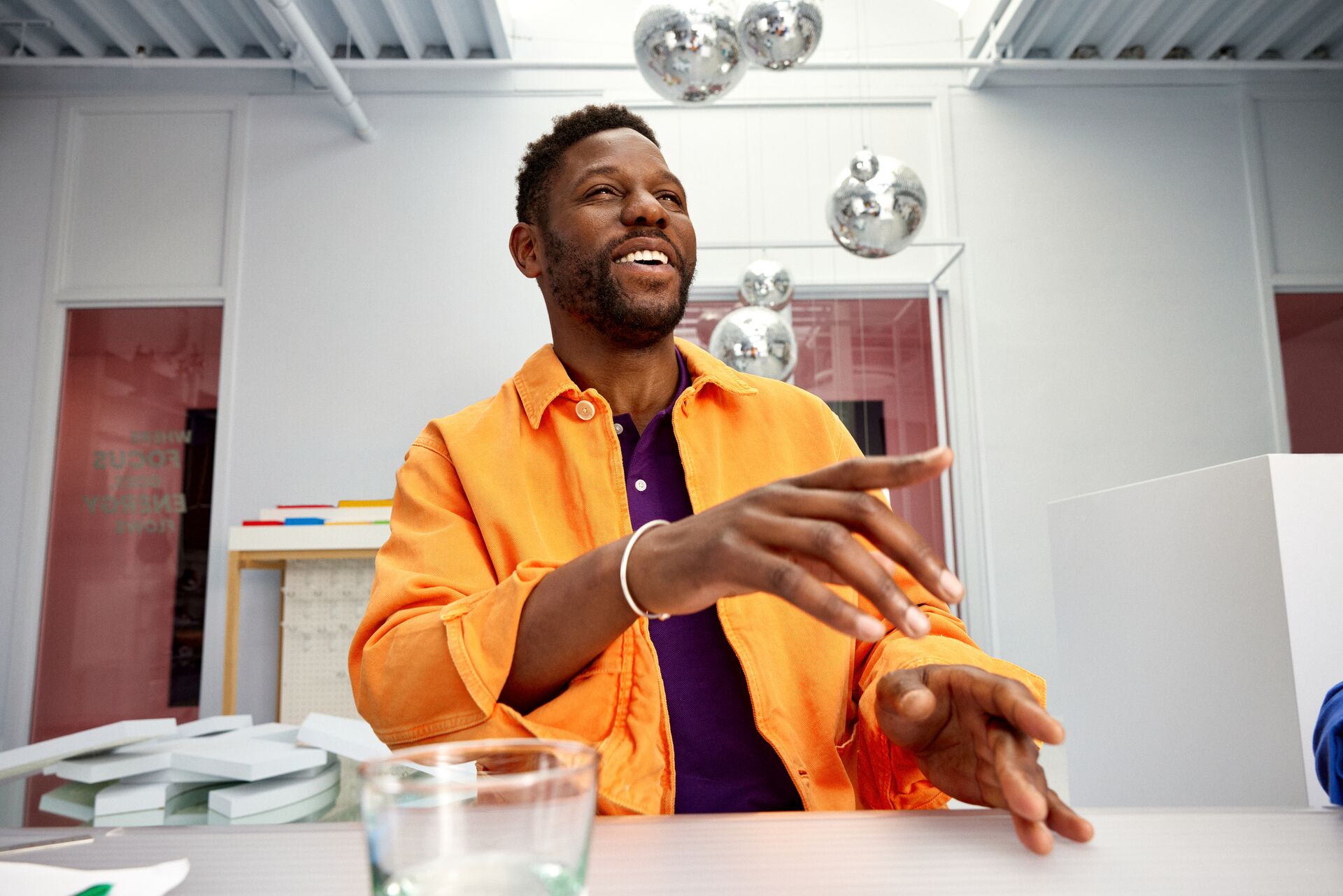 Man in orange pointing at something