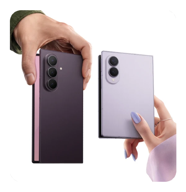 Two hands holding a foldable smartphone open in book form; one side is black, the other light purple, each with multiple cameras.